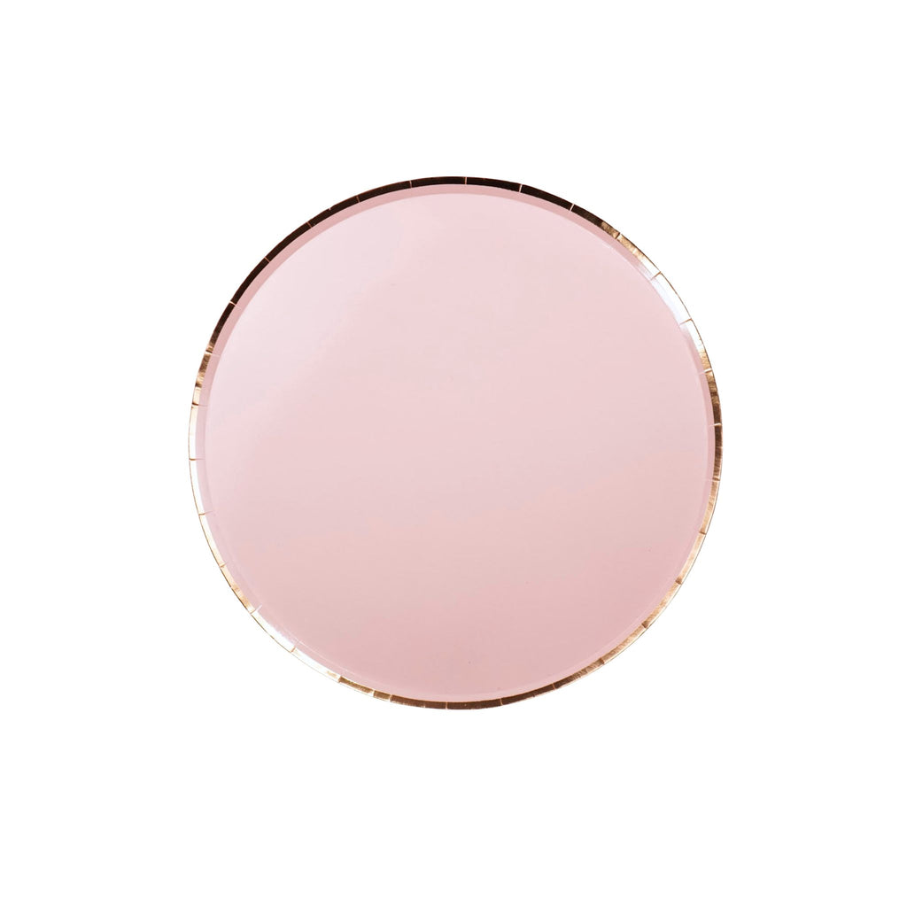 Round pink plate with gold rim on a white background