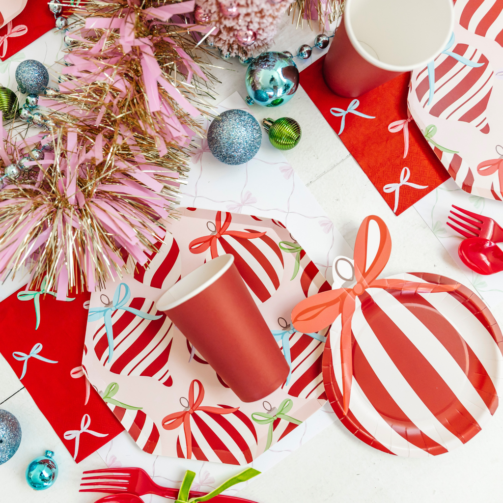 Red and white festive tableware with Christmas decorations on a white background
