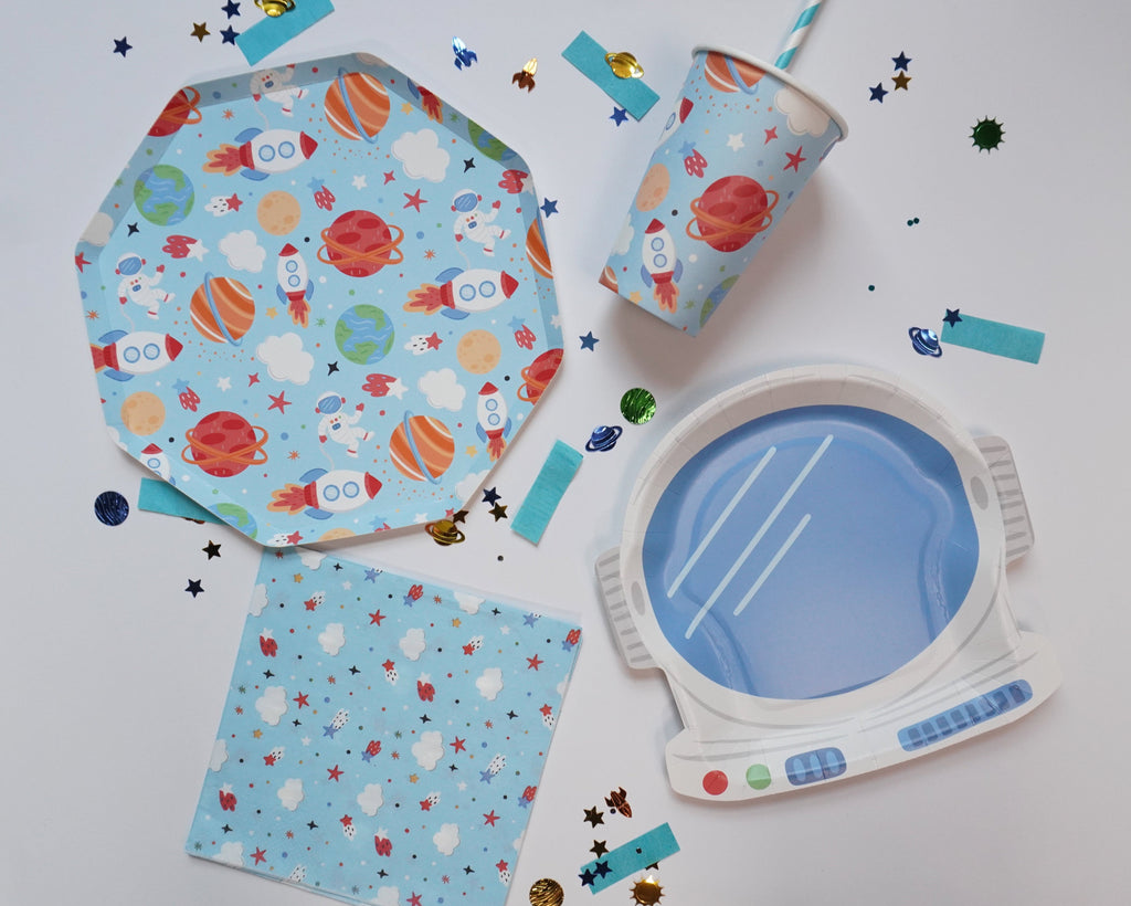 Space-themed birthday party supplies with plates, cups, and napkin by Festive Fun Co.