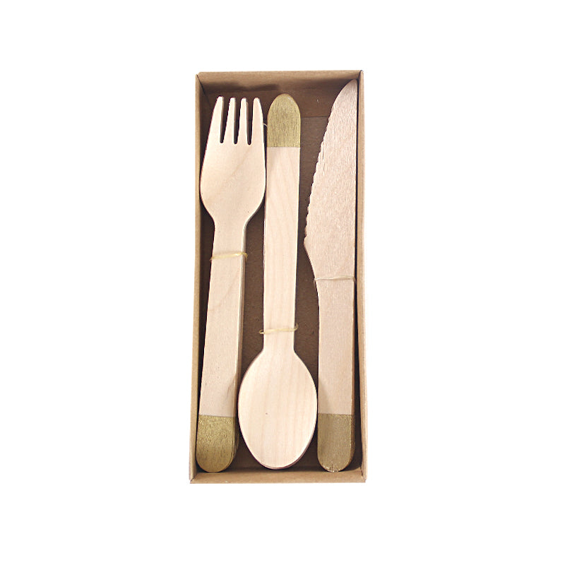 Set of wooden cutlery with gold accents in a box on a white background